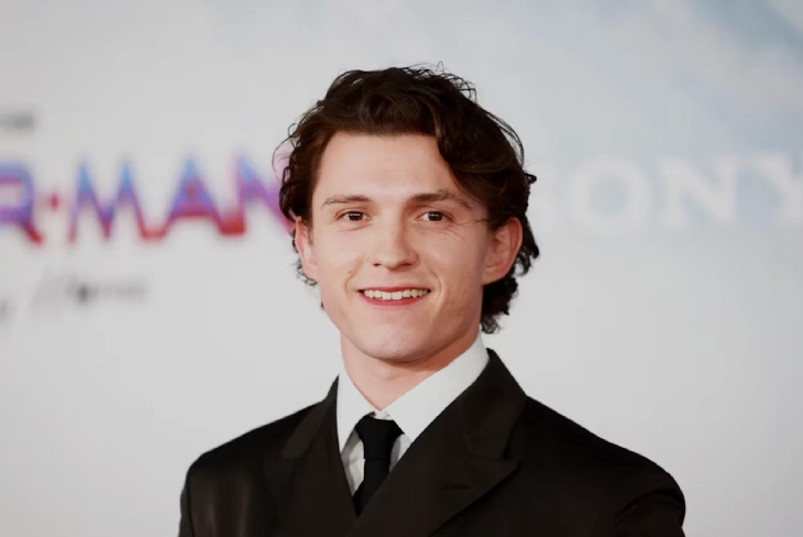 An engaging image showcasing Tom Holland with text overlay stating "Tom Holland Net Worth."